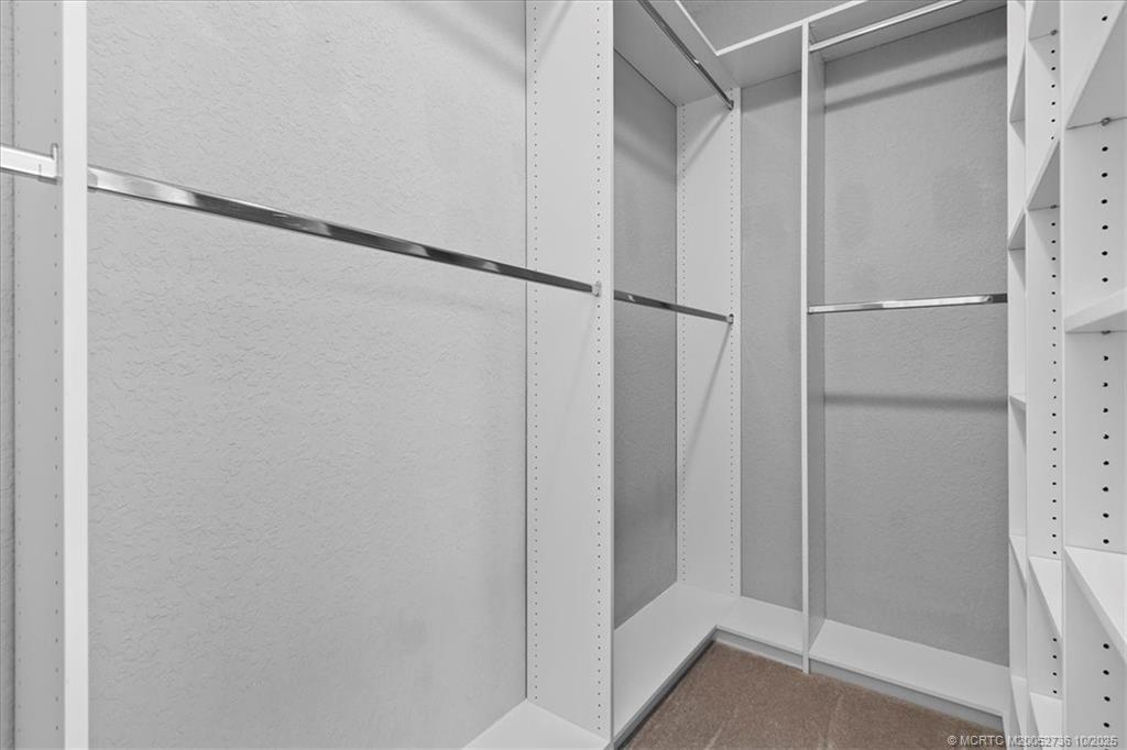 692 Southwest Glen Crest Way Stuart, FL 34997 - Photo 16 of 38 a bathroom with a glass shower door