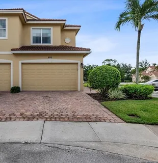 a sign board with flower on the side of the road