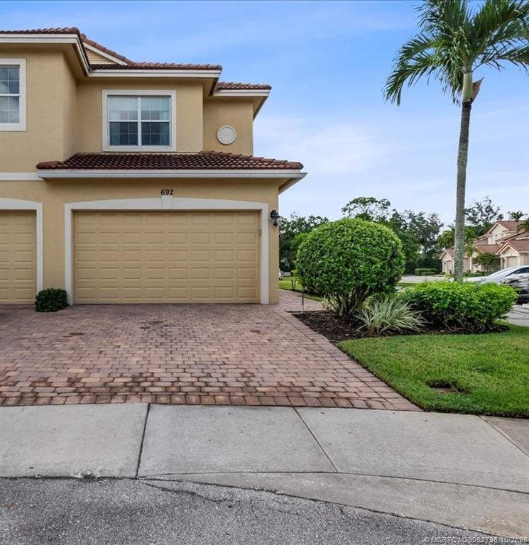 692 Southwest Glen Crest Way Stuart, FL 34997 - Photo 26 of 38 a front view of a house with garden