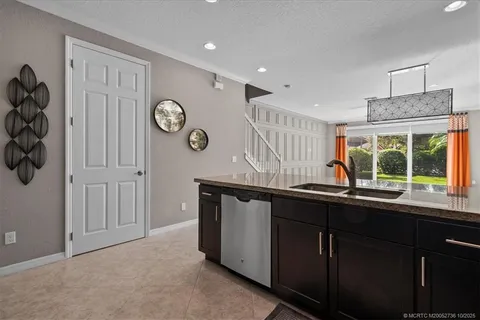 a kitchen with a sink window and cabinets