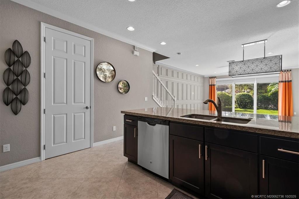 692 Southwest Glen Crest Way Stuart, FL 34997 - Photo 3 of 38 a kitchen with a sink window and cabinets
