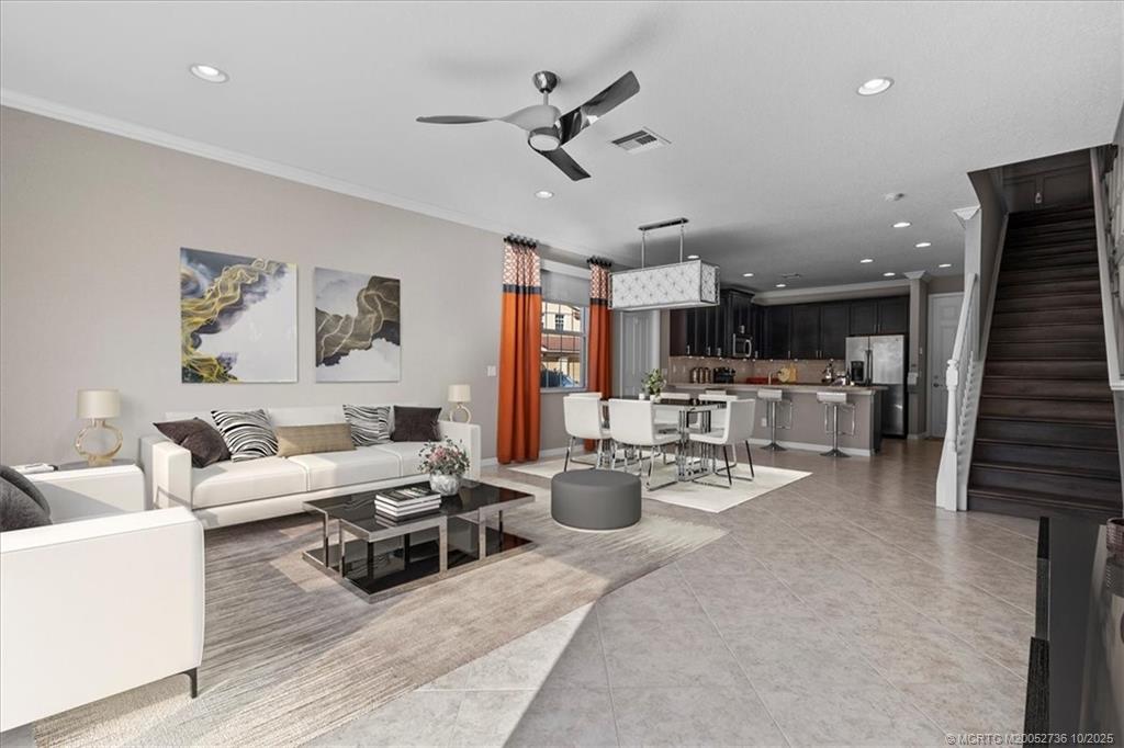 692 Southwest Glen Crest Way Stuart, FL 34997 - Photo 5 of 38 a living room with furniture kitchen view and a chandelier