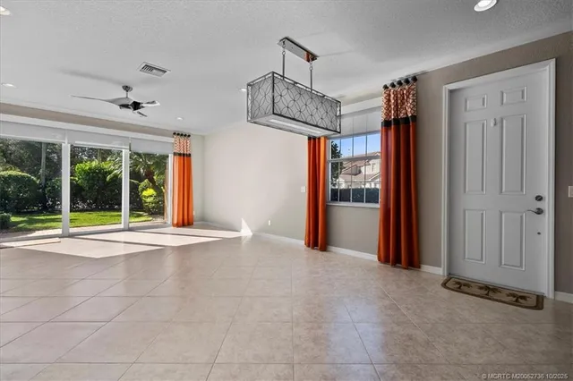 a view of an empty room with a fireplace and a large window