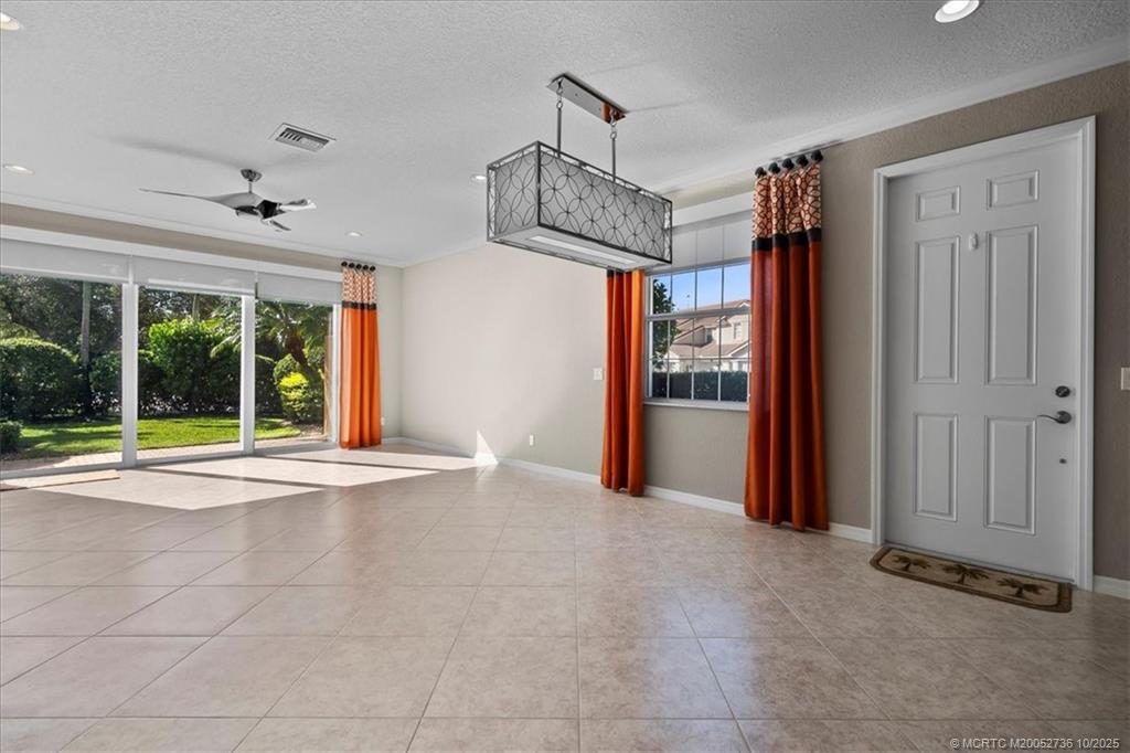 692 Southwest Glen Crest Way Stuart, FL 34997 - Photo 8 of 38 a view of an empty room with a fireplace and a large window