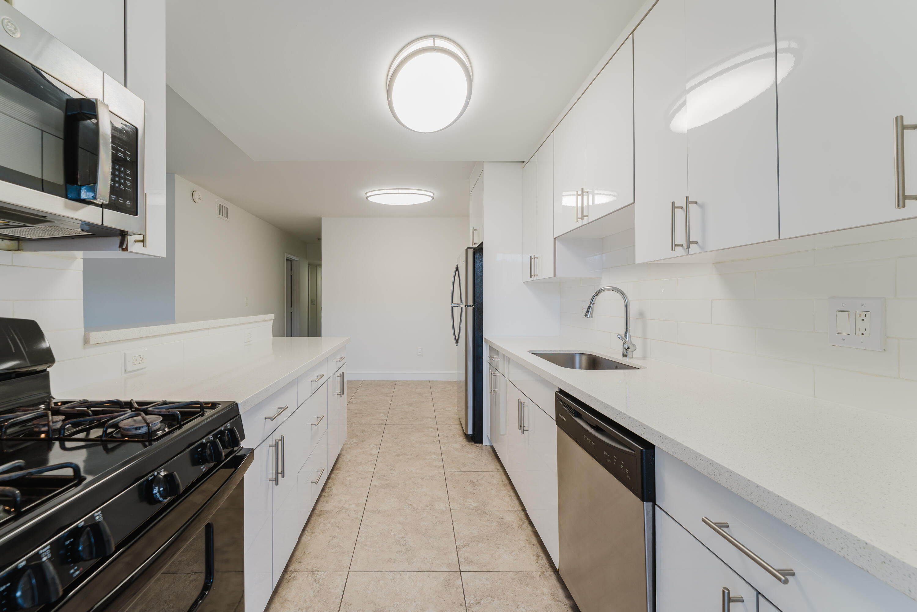 601 Southwest 2nd Avenue, Unit 5 Boca Raton, FL 33432 - Photo 13 of 26 a kitchen with stainless steel appliances a sink stove and cabinets