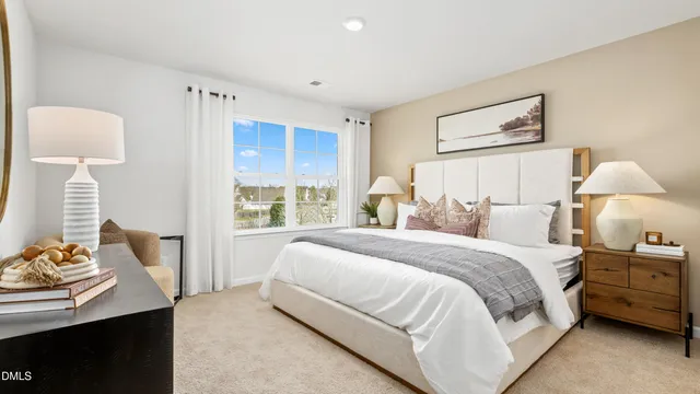 a bedroom with a bed and a lamp on table