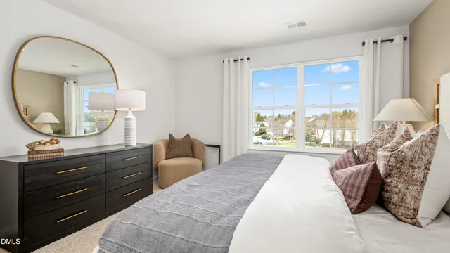 a bed room with a bed mirror and window