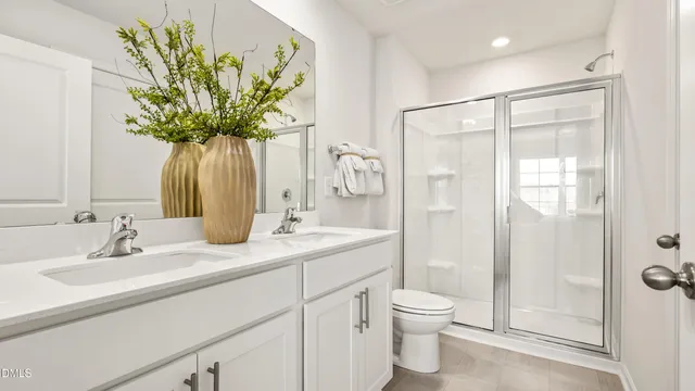 a bathroom with a granite countertop sink a toilet and shower