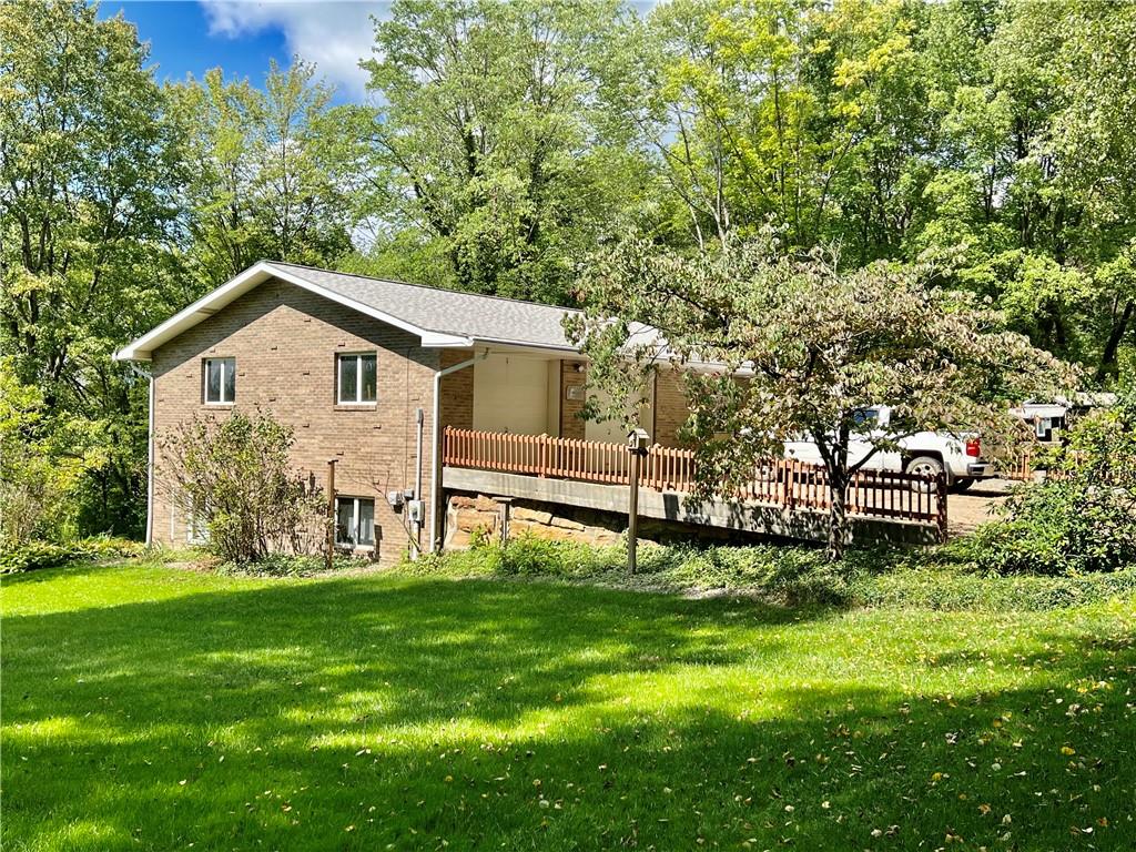 672 New Castle Road Slippery Rock, PA 16057 - Photo 4 of 9 a front view of a house with a yard and trees