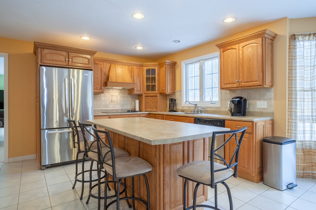 152 Old Worcester Road Charlton, MA 01507 - Photo 3 of 28 a kitchen with stainless steel appliances granite countertop a refrigerator a sink a stove and island