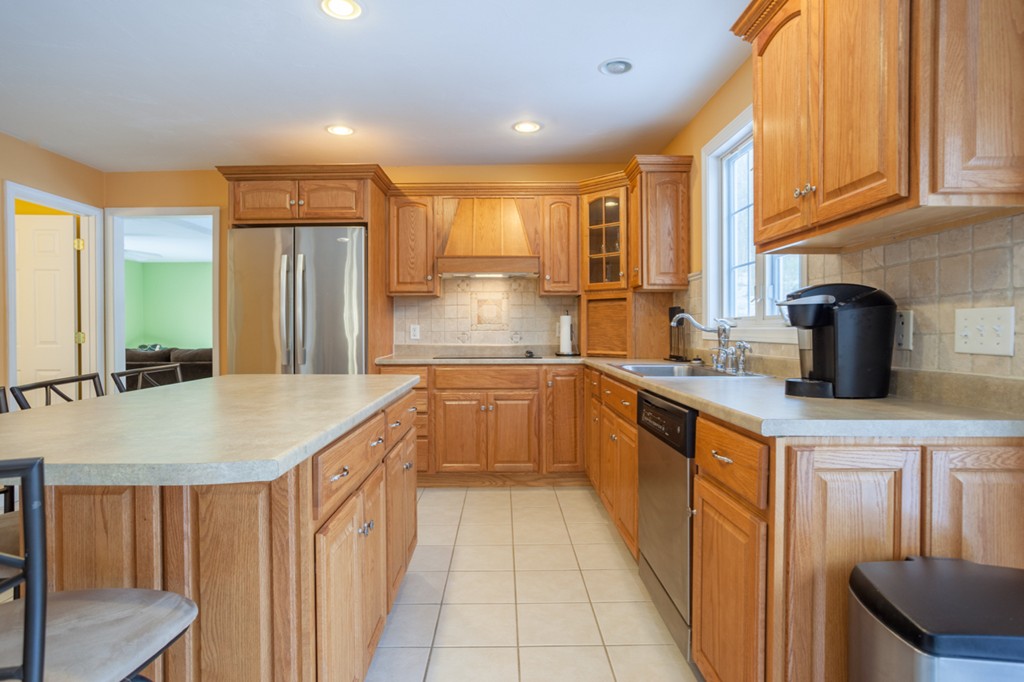 152 Old Worcester Road Charlton, MA 01507 - Photo 4 of 28 a kitchen with kitchen island granite countertop a sink and refrigerator