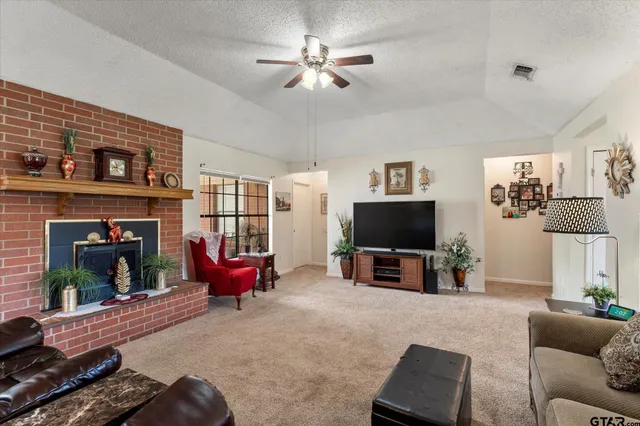 a living room with furniture and a fireplace
