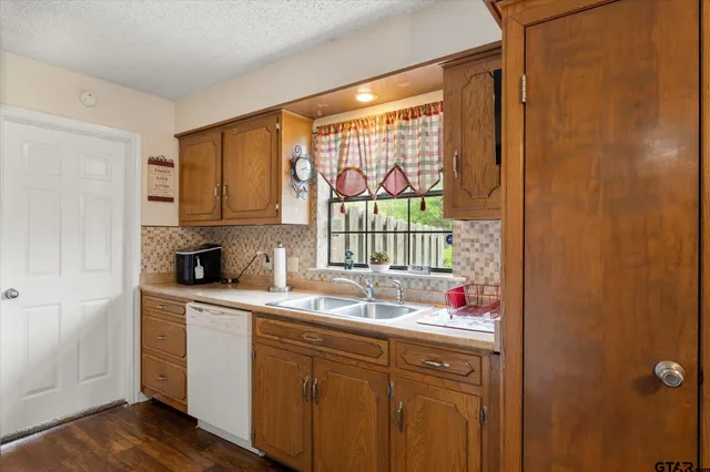 a kitchen with a sink window and cabinets