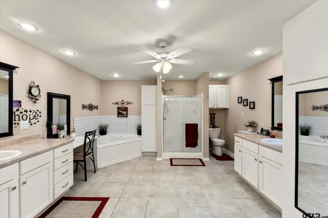 a large white kitchen with stainless steel appliances kitchen island granite countertop a sink and cabinets