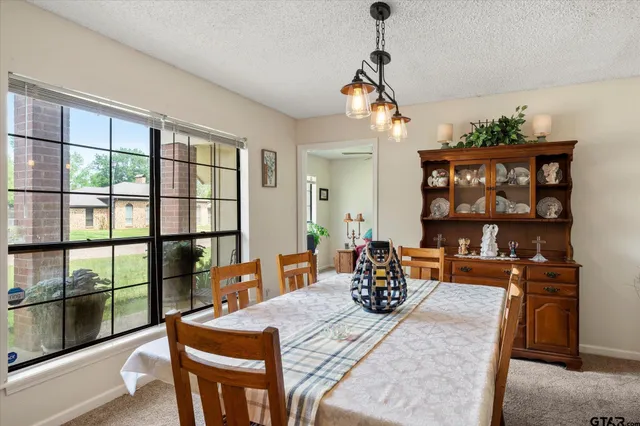 a view of a dining room with furniture window and outside view