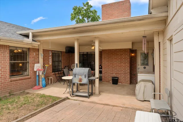 a view of a patio with chair and tables