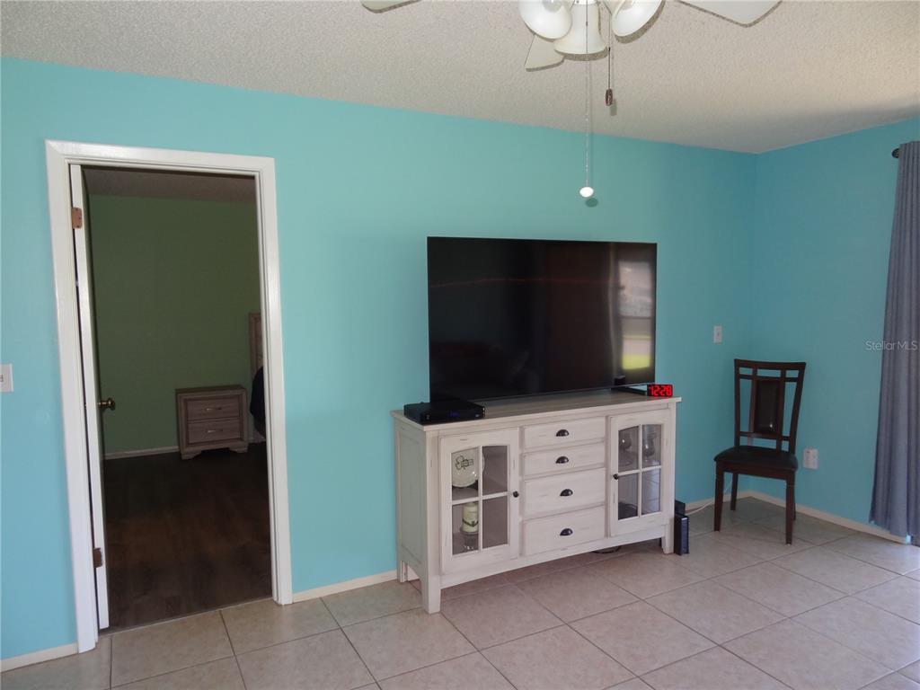 11135 Carriage Hill Drive, Unit 3 Port Richey, FL 34668 - Photo 13 of 25 a living room with furniture and a flat screen tv