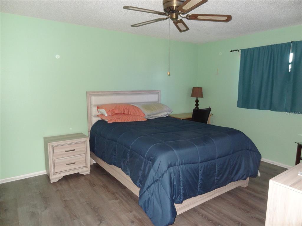11135 Carriage Hill Drive, Unit 3 Port Richey, FL 34668 - Photo 15 of 25 a bedroom with a bed and a cabinets