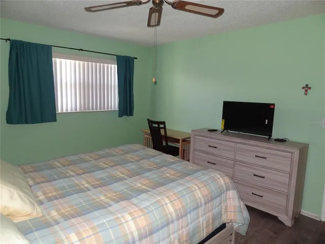 a bedroom with a bed and a television