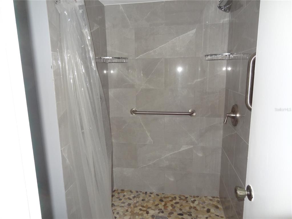 11135 Carriage Hill Drive, Unit 3 Port Richey, FL 34668 - Photo 17 of 25 a bathroom with a shower