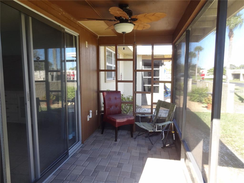 11135 Carriage Hill Drive, Unit 3 Port Richey, FL 34668 - Photo 20 of 25 a living room with furniture and a floor to ceiling window