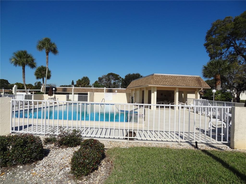 11135 Carriage Hill Drive, Unit 3 Port Richey, FL 34668 - Photo 23 of 25 a view of a house with a yard