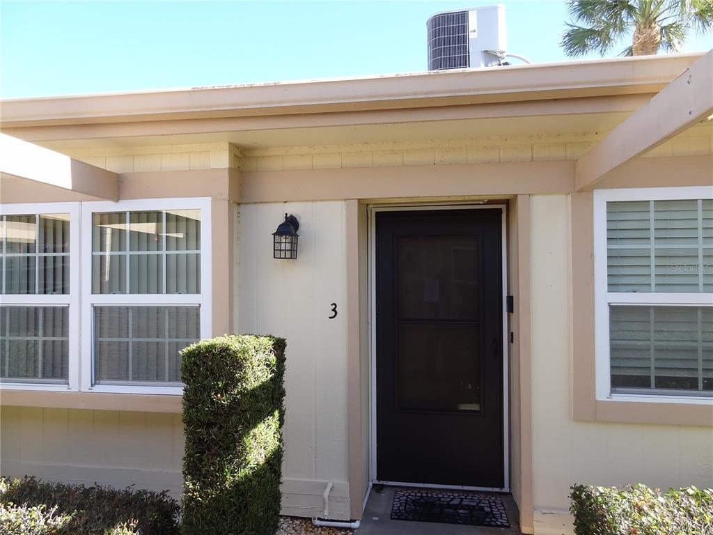 11135 Carriage Hill Drive, Unit 3 Port Richey, FL 34668 - Photo 3 of 25 a front view of a house with a yard