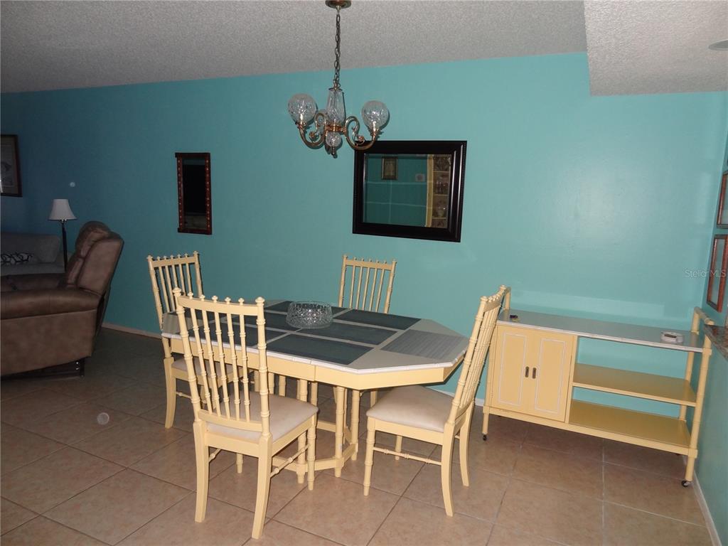 11135 Carriage Hill Drive, Unit 3 Port Richey, FL 34668 - Photo 9 of 25 a view of a dining room with furniture