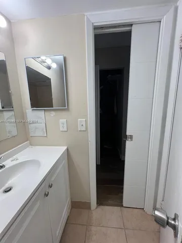 a bathroom with a sink and mirror