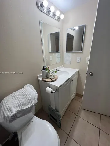 a bathroom with a sink toilet and mirror