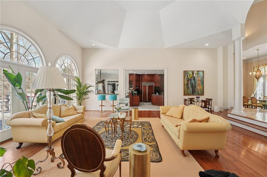 1296 Niskey Lake Road Southwest Atlanta, GA 30331 - Photo 12 of 88 a living room with furniture a fireplace and a chandelier