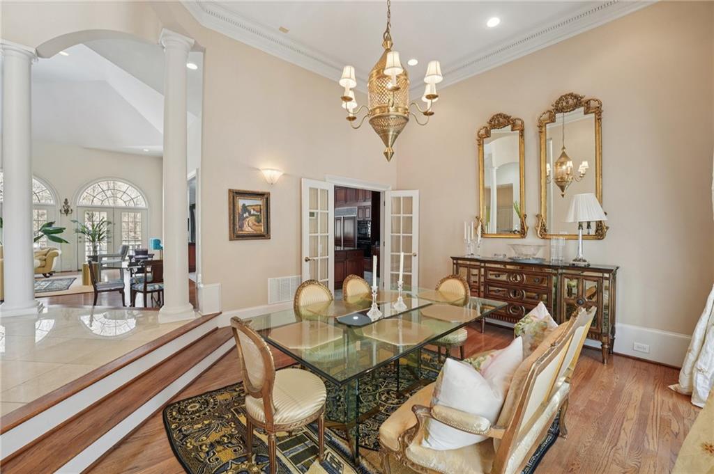 1296 Niskey Lake Road Southwest Atlanta, GA 30331 - Photo 14 of 88 a dining room with wooden floor a chandelier a glass table and chairs