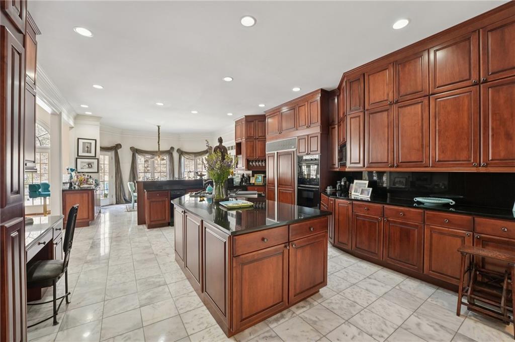 1296 Niskey Lake Road Southwest Atlanta, GA 30331 - Photo 20 of 88 a kitchen with stainless steel appliances kitchen island granite countertop a stove top oven a sink a refrigerator and cabinets