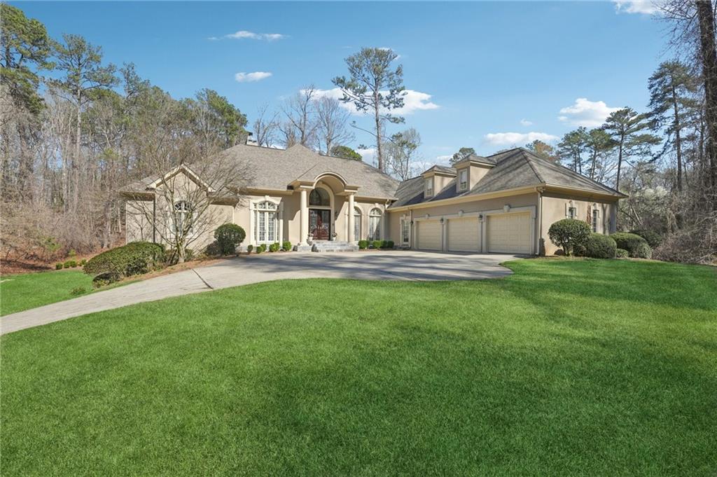 1296 Niskey Lake Road Southwest Atlanta, GA 30331 - Photo 2 of 88 a front view of a house with a garden and trees