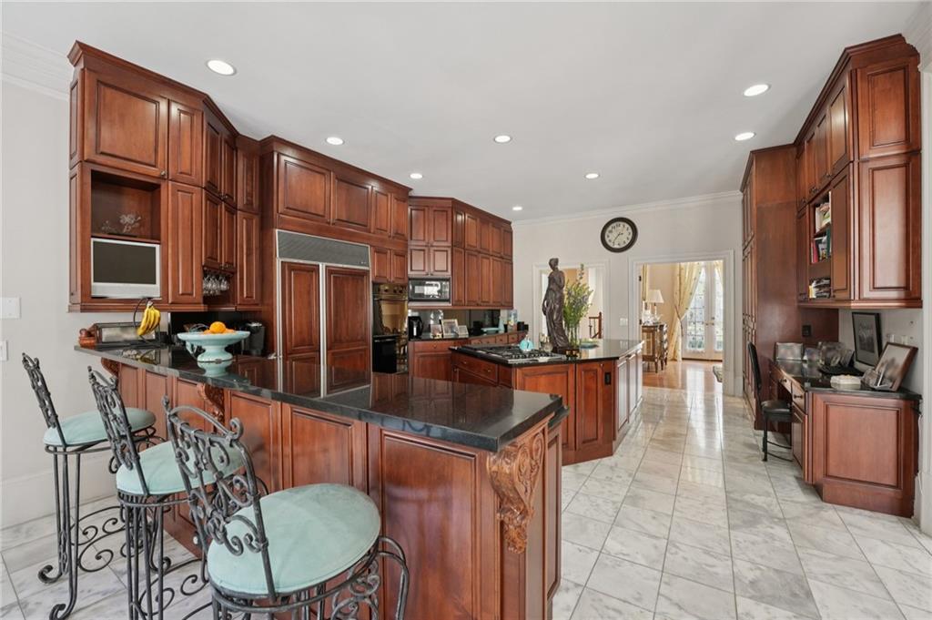 1296 Niskey Lake Road Southwest Atlanta, GA 30331 - Photo 22 of 88 a kitchen with stainless steel appliances granite countertop a refrigerator a stove a sink a dining table and chairs with wooden floor