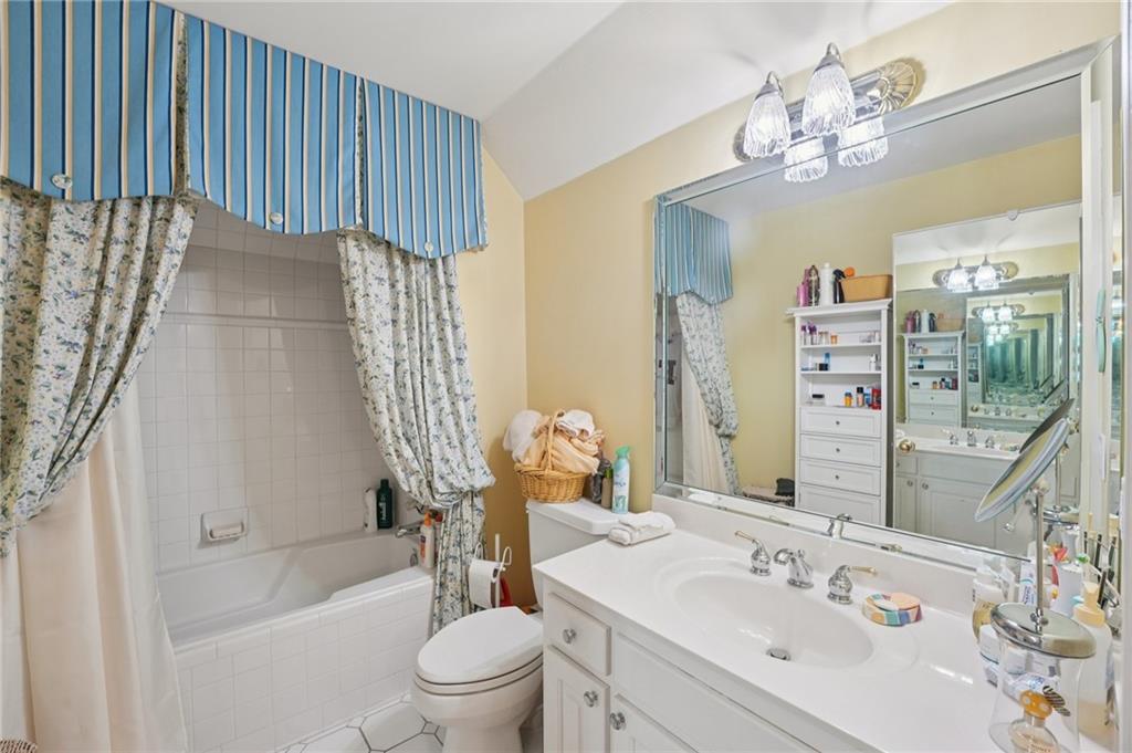 1296 Niskey Lake Road Southwest Atlanta, GA 30331 - Photo 34 of 88 a bathroom with a sink a toilet a mirror a bathtub and shower