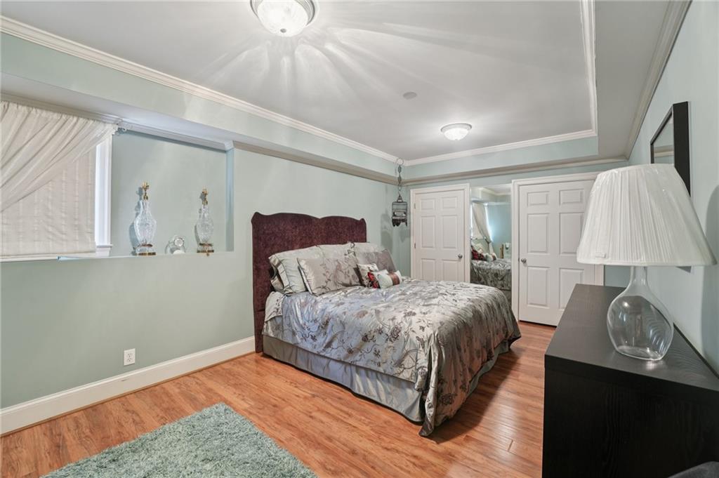 1296 Niskey Lake Road Southwest Atlanta, GA 30331 - Photo 51 of 88 a bedroom with a bed and a lamp on dresser
