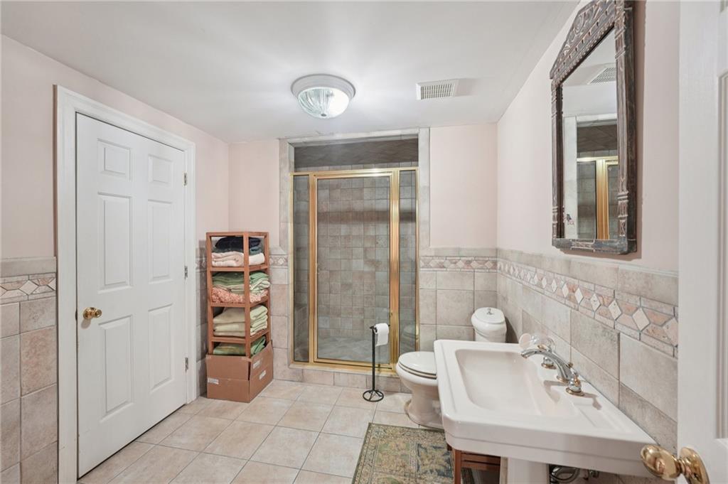 1296 Niskey Lake Road Southwest Atlanta, GA 30331 - Photo 64 of 88 a bathroom with a sink a toilet and shower