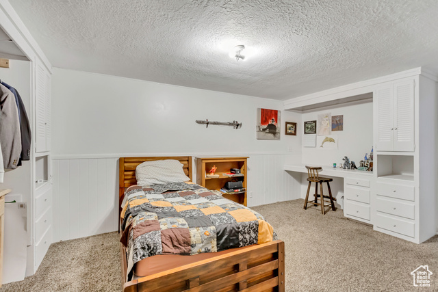 360 East Center Street Centerville, UT 84014 - Photo 40 of 41 Bedroom with light colored carpet and a textured ceiling