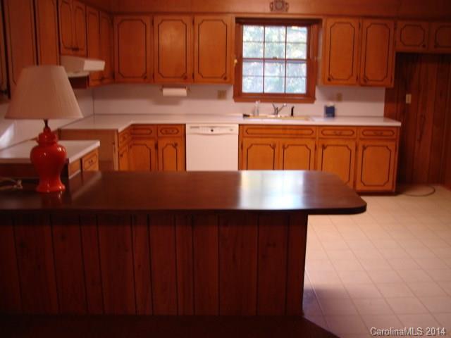 147 Ashbrook Rd Point, Unit 27 Statesville, NC 28677 - Photo 16 of 24 a kitchen with stainless steel appliances granite countertop a sink a stove top oven a dining table and chairs