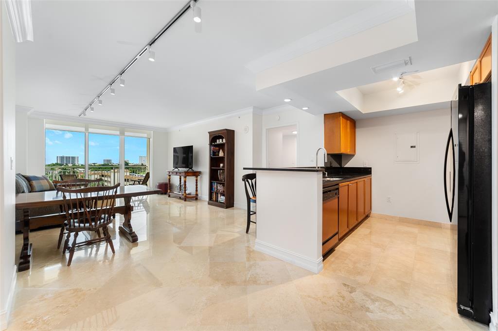 99 Southeast Mizner Boulevard, Unit 603 Boca Raton, FL 33432 - Photo 13 of 34 a kitchen with stainless steel appliances kitchen island granite countertop a refrigerator and a stove top oven