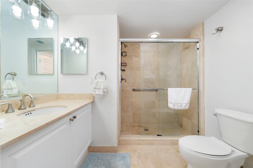 99 Southeast Mizner Boulevard, Unit 603 Boca Raton, FL 33432 - Photo 15 of 34 a bathroom with a sink a toilet and shower