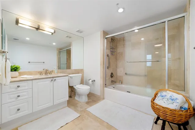 a bathroom with a bathtub shower sink and toilet
