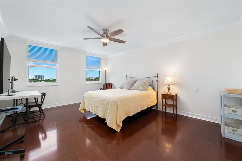 99 Southeast Mizner Boulevard, Unit 603 Boca Raton, FL 33432 - Photo 21 of 34 a bedroom with a bed and a table in it