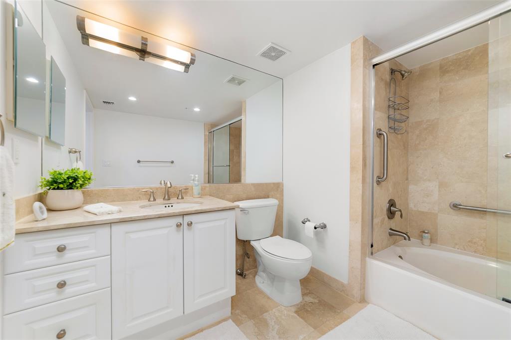 99 Southeast Mizner Boulevard, Unit 603 Boca Raton, FL 33432 - Photo 22 of 34 a bathroom with a granite countertop sink a toilet and shower