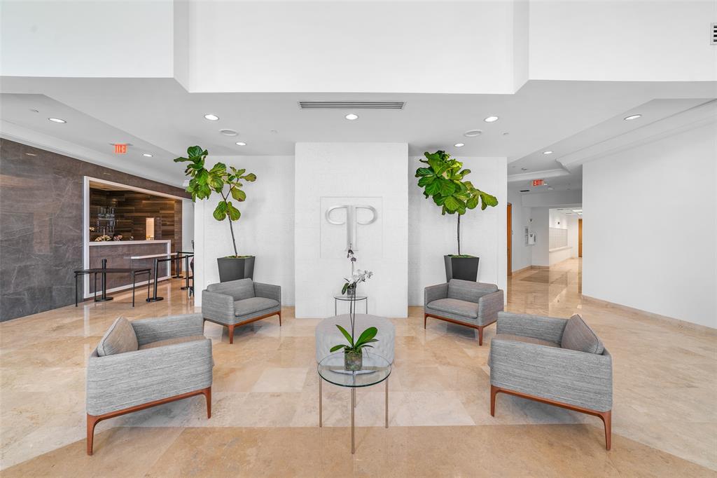 99 Southeast Mizner Boulevard, Unit 603 Boca Raton, FL 33432 - Photo 31 of 34 a living room with furniture and a potted plant