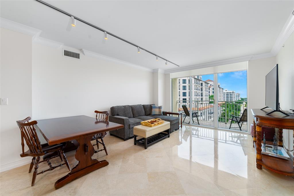 99 Southeast Mizner Boulevard, Unit 603 Boca Raton, FL 33432 - Photo 5 of 34 a living room with furniture and a flat screen tv