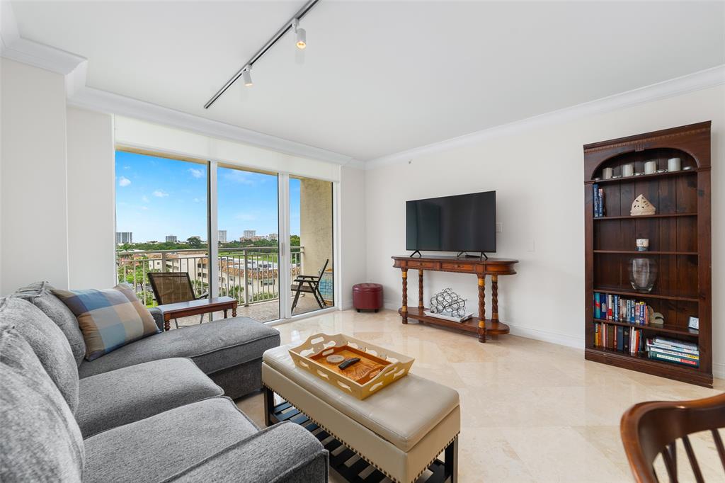 99 Southeast Mizner Boulevard, Unit 603 Boca Raton, FL 33432 - Photo 6 of 34 a living room with furniture and a flat screen tv