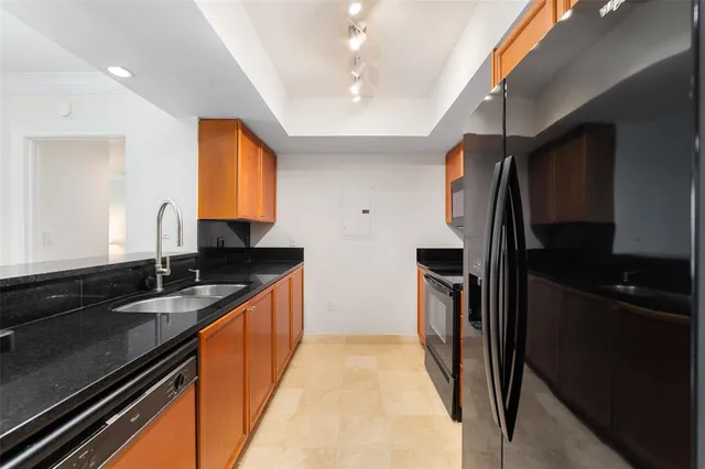 a kitchen with stainless steel appliances granite countertop a sink stove and refrigerator