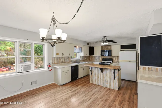 a kitchen with stainless steel appliances granite countertop a stove and a sink